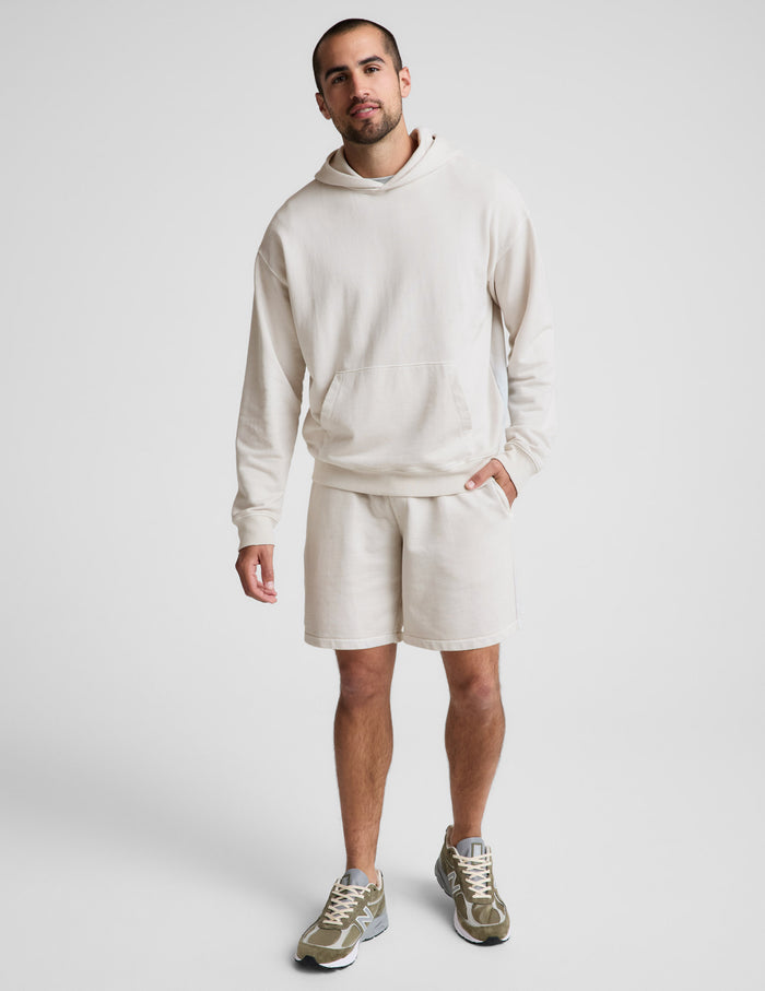 Man wearing Cream Beach Washed Terry Men's Short™ paired with a matching cream hoodie and olive sneakers.