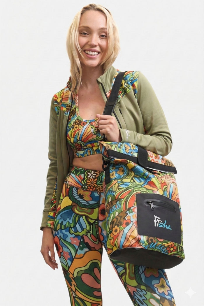 Woman holding a colorful bag with a patterned outfit on a white background