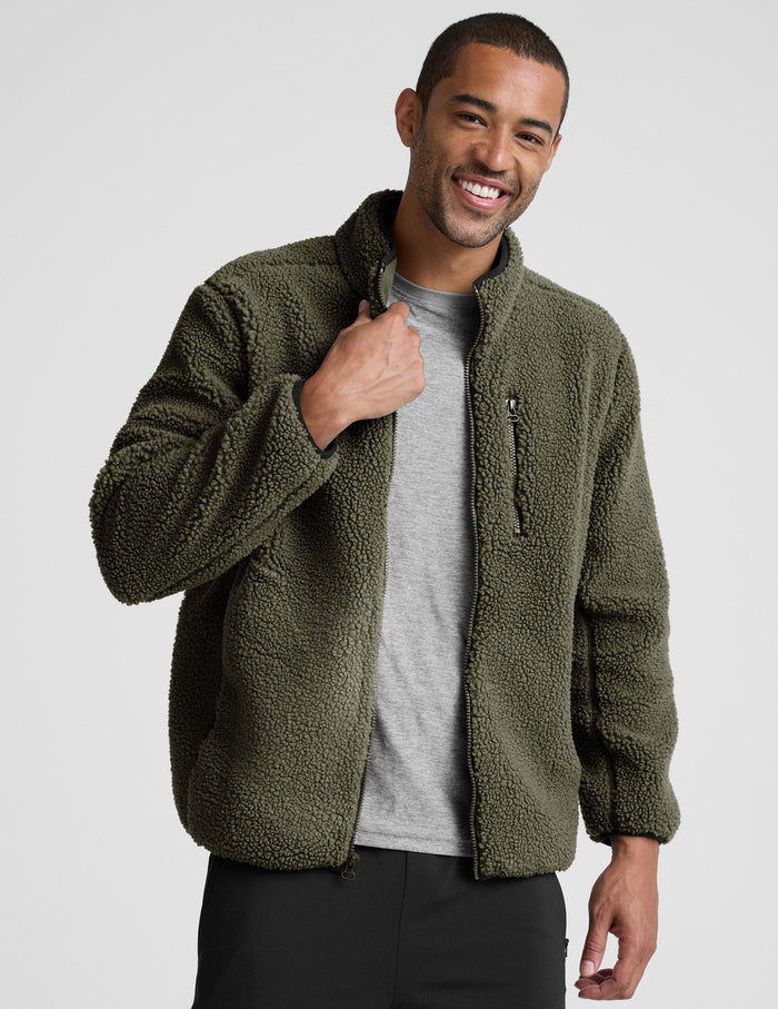 model wearing a men's green fleece zip-up jacket on a light gray background.