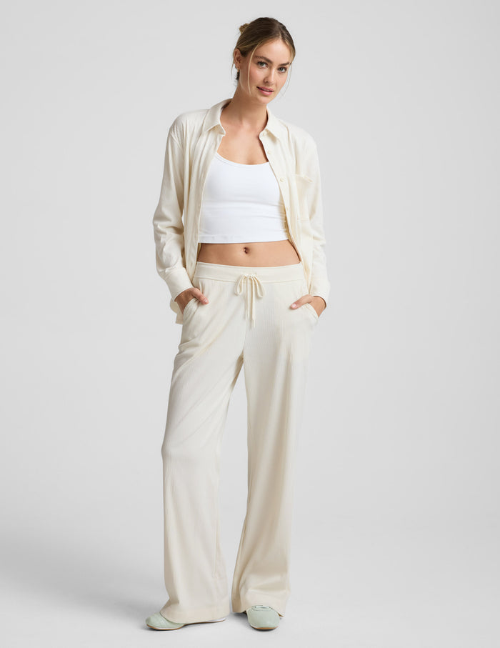 Model wears cream Breathe Easy Comfort Cord Pant, wide-leg corduroy pants with a drawstring waist and side pockets.