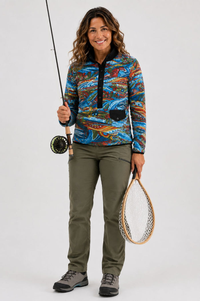 Waist-up studio hero image of a woman wearing the Charvana Riffle Snap Fleece, showing the full front design.