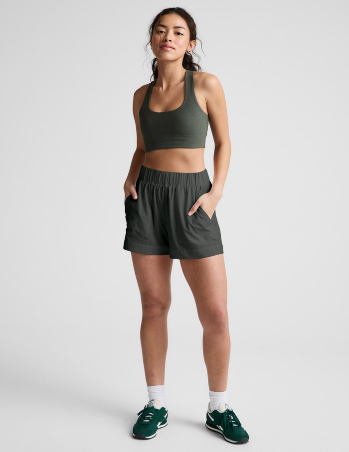 Model wearing the dark gray Easy 3" Short with a gathered elastic waistband, mid-rise fit, and side seam pockets.