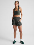 Model wearing the dark gray Easy 3" Short with a gathered elastic waistband, mid-rise fit, and side seam pockets.