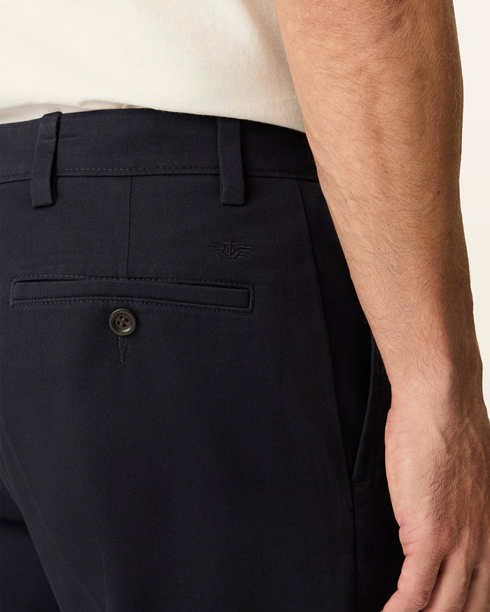 Side view of model wearing Navy Easy Khakis, Classic Fit.