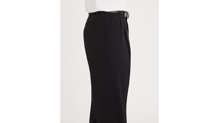 Side view of model wearing Dark Pebble Easy Khakis, Pleated, Classic Fit (Big and Tall).