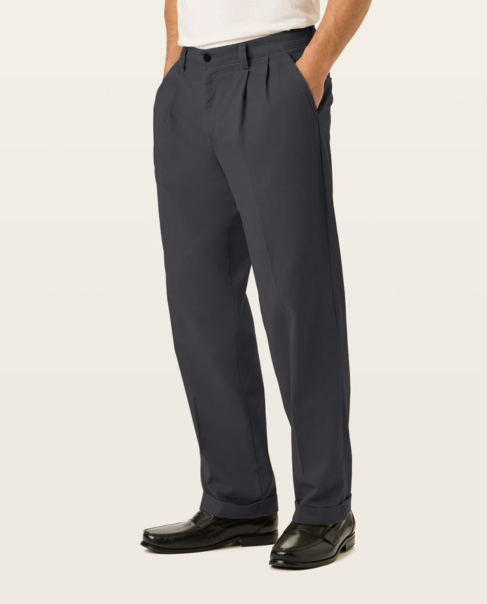 Side view of model wearing Black Easy Stretch Khakis, Pleated, Relaxed Fit.