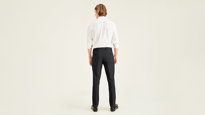 Back view of model wearing Black Easy Khakis, Slim Fit.