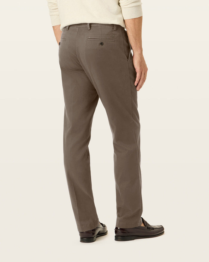 Side view of model wearing Dark Pebble Easy Khakis, Straight Fit.
