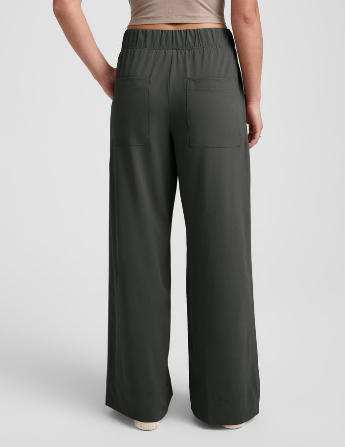 Back view of Easy Wide Leg Pant 31" in dark olive, showing its elastic waist, back pockets, and relaxed wide leg silhouette.