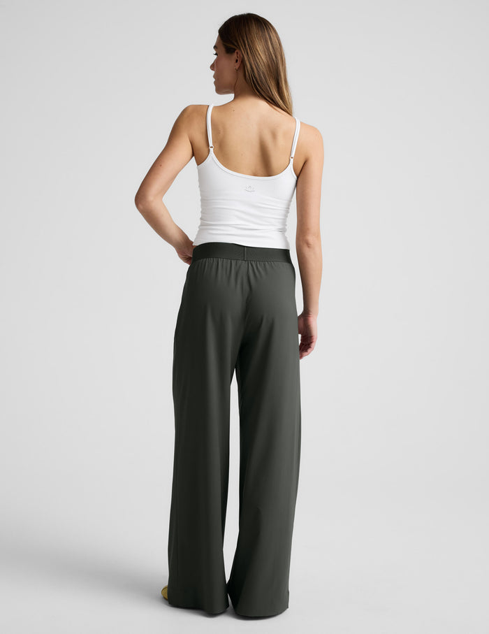 Rear view of a model wearing dark green wide-leg Elasticated Trouser Pant 31" with a comfortable elastic waistband.