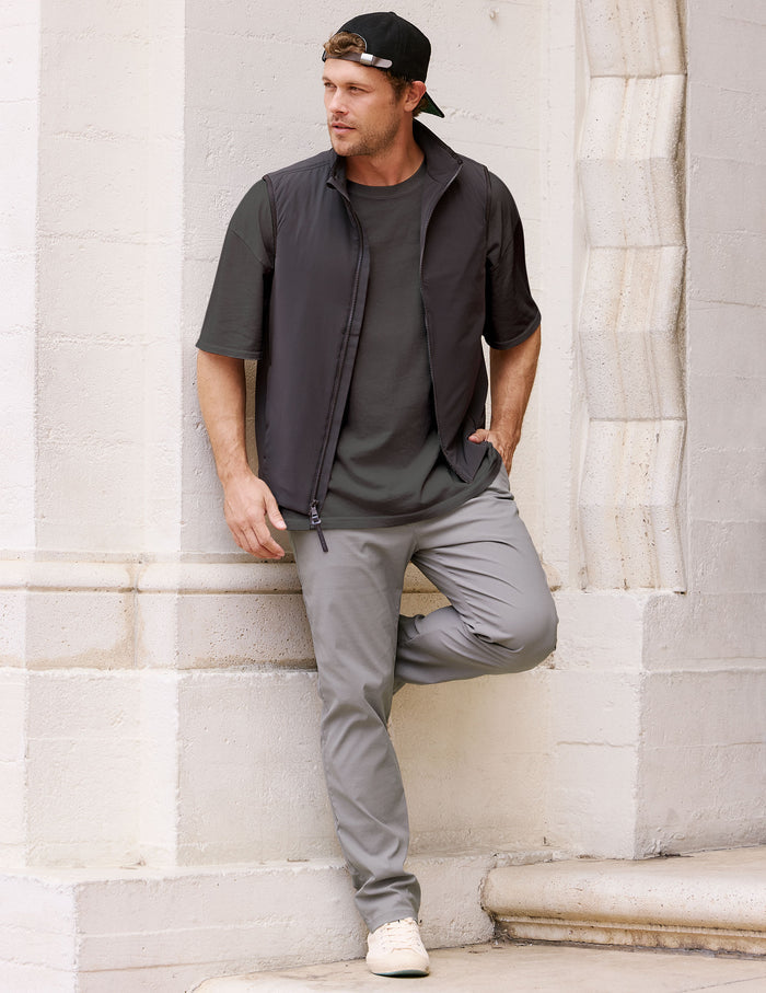 Man wearing the gray Element Men's Chino Trouser with a straight-leg fit, leaning against a white stone pillar.