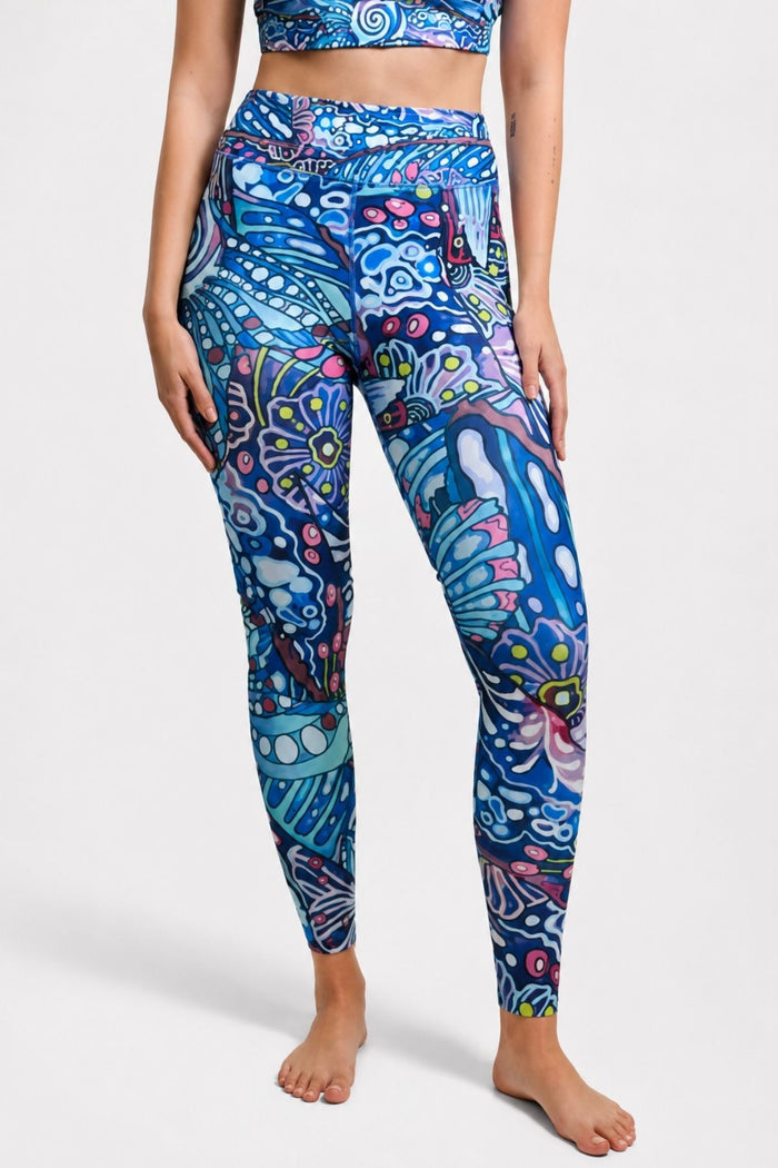 Person wearing colorful patterned leggings on a white background