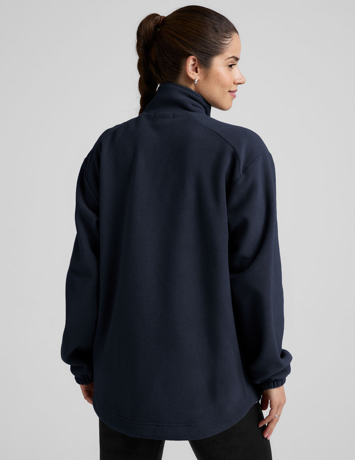 blue fleece button up jacket with a full front zip and snap closures and pockets.