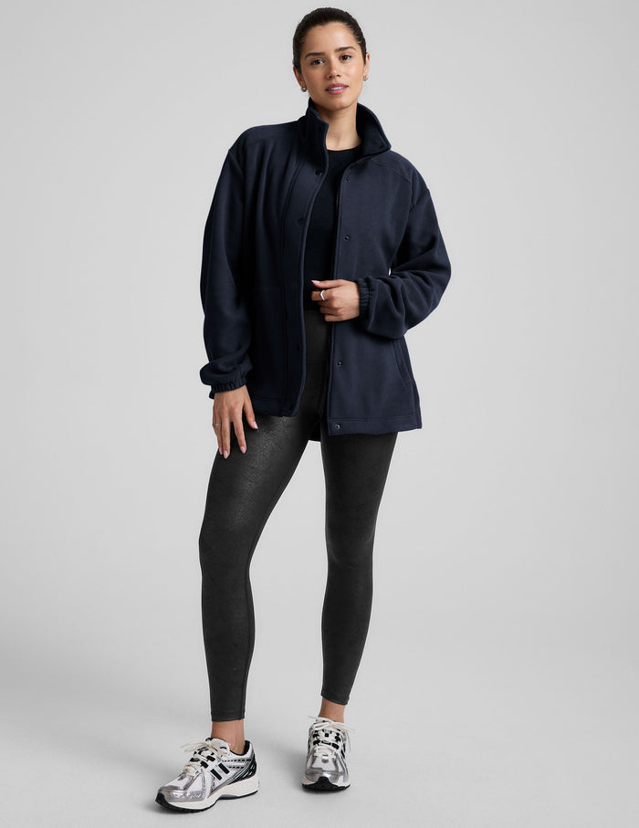 blue fleece button up jacket with a full front zip and snap closures and pockets.