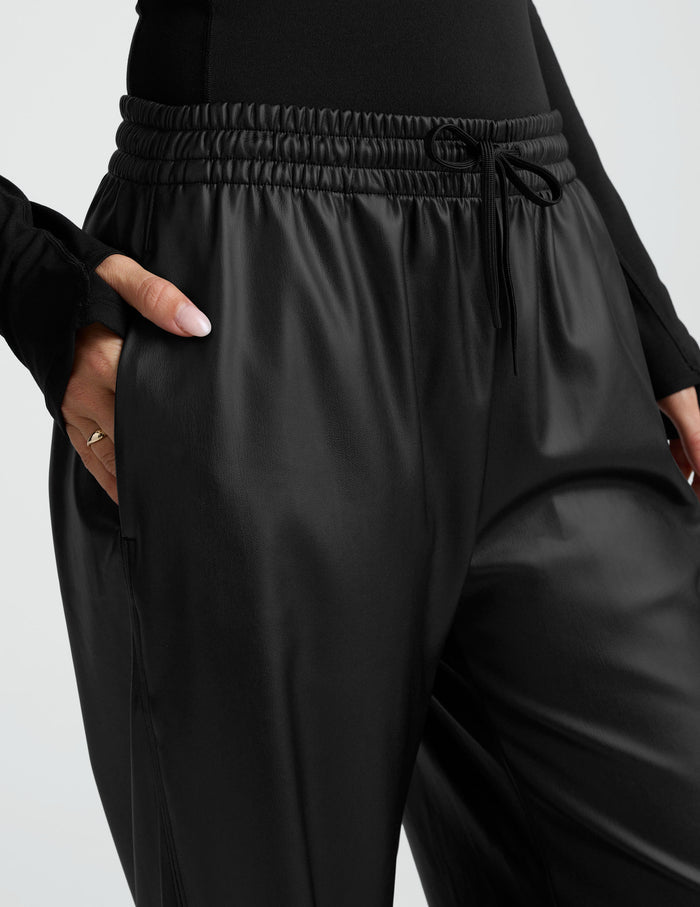 Close-up of the black Faux Leather Pant featuring a gathered elastic waistband with drawstrings and side pockets.