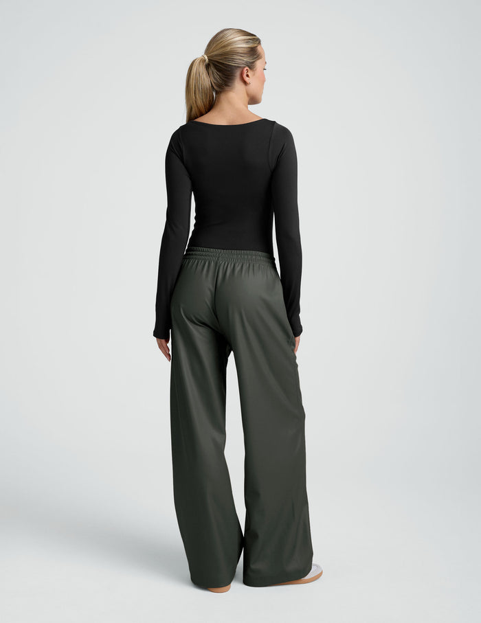 Back view of olive-colored, wide-leg Faux Leather Pant featuring a gathered elastic waistband.