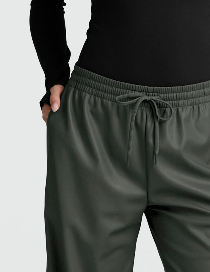 Olive Faux Leather Pant featuring a gathered elastic waistband with drawstring and side pocket detail.
