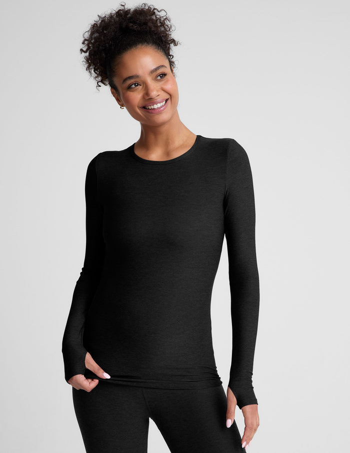 black crew neck long sleeve top with thumb holes.