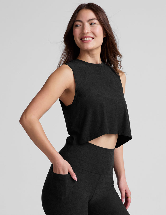 black relaxed fit and cropped tank top with a ribbed scooped neckline and ribbed arm holes.