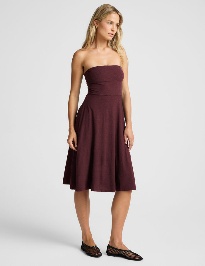 red strapless midi length dress with pockets.