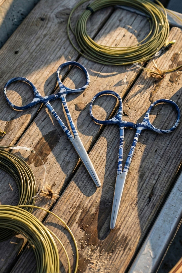 Pair of blue-handled scissors on a wooden surface with fishing line.