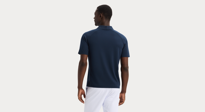 Back view of model wearing Navy Blazer Go Polo, Regular Fit.