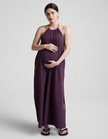 Woman wearing a purple dress against a plain background.