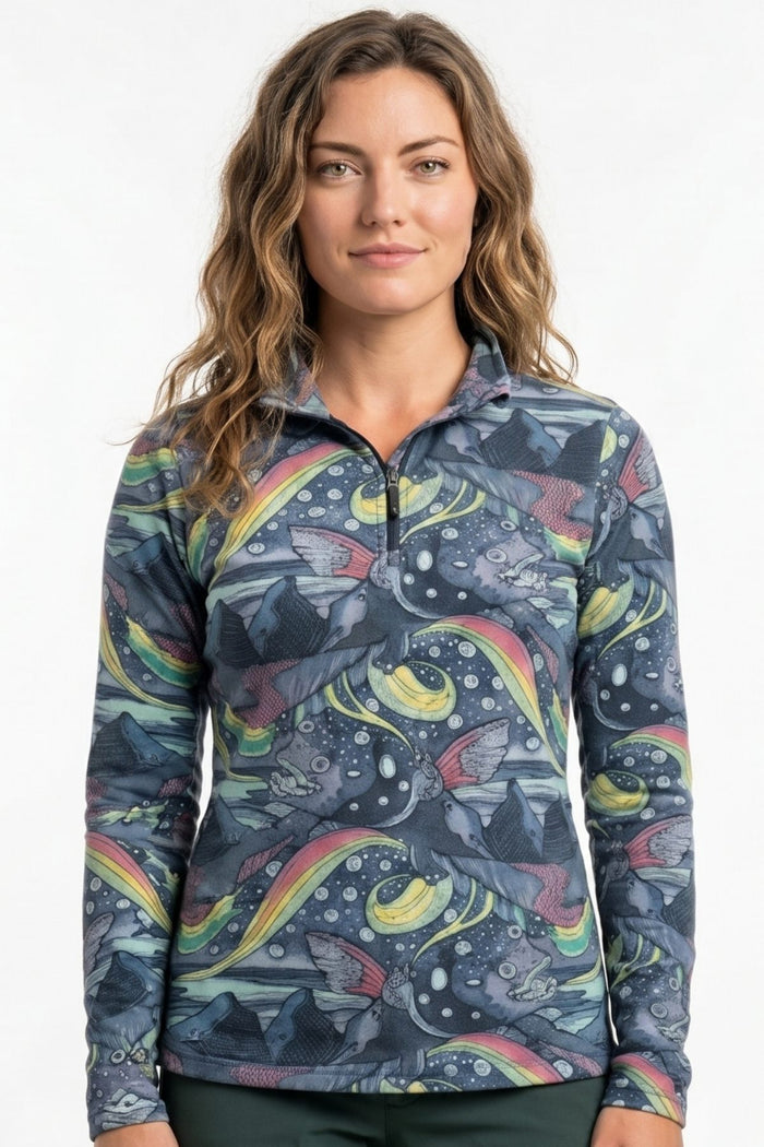 Woman wearing a colorful patterned long-sleeve shirt against a white background