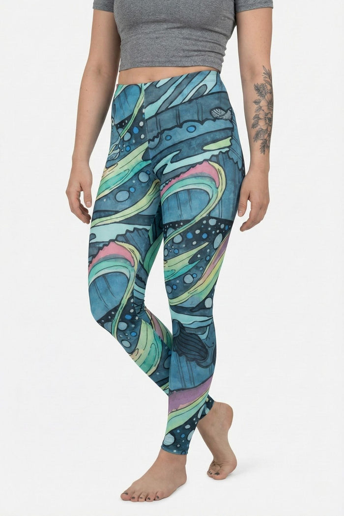 Person wearing colorful patterned leggings on a white background