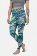 Person wearing colorful patterned leggings on a white background