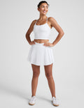 white pleated mini skirt with shorts underneath.