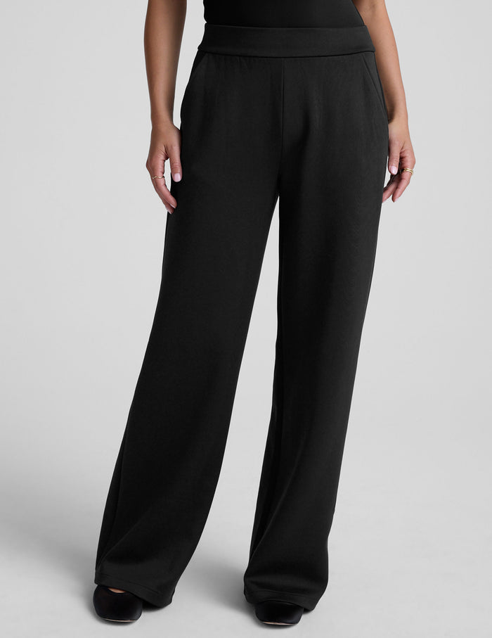 Black In The Flow Wide Leg Pant with a high elastic waistband, front pockets, and a loose, full-length silhouette.