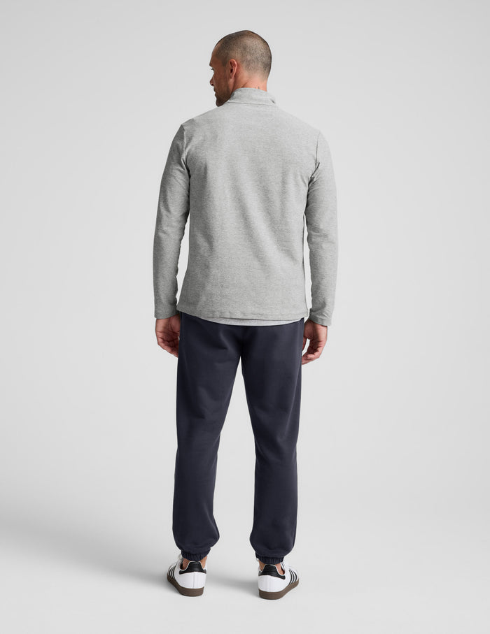 Rear view of a man wearing the Classic Fleece Men's Jogger in dark gray, featuring a relaxed fit and elasticated cuffs.