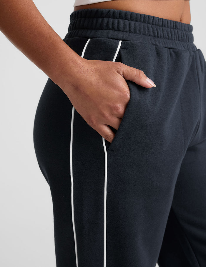 Navy LuxeFleece Piper Wide Leg Pant featuring an elastic waistband, side slant pockets, and white contrast piping detail.