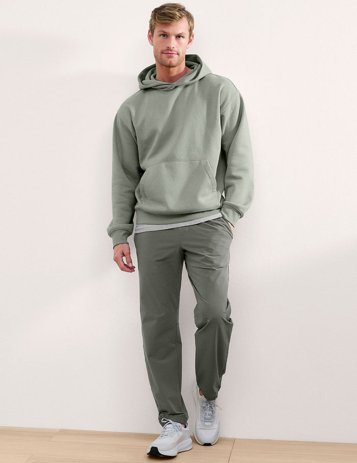 Olive On The Go Men's Jogger on a man, featuring a relaxed fit, cuffed ankles, and elastic waistband in a studio shot.