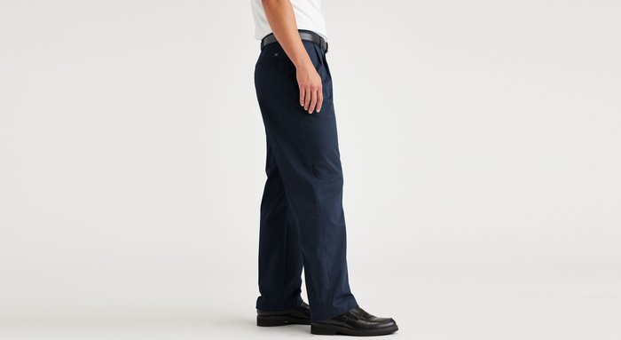 Side view of model wearing Navy Blazer Essential Chinos, Pleated, Classic Fit.