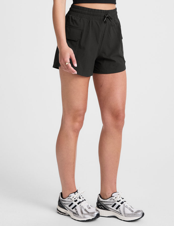 Black Peak 3" Short on a model featuring an elastic drawstring waistband and side cargo patch pockets.