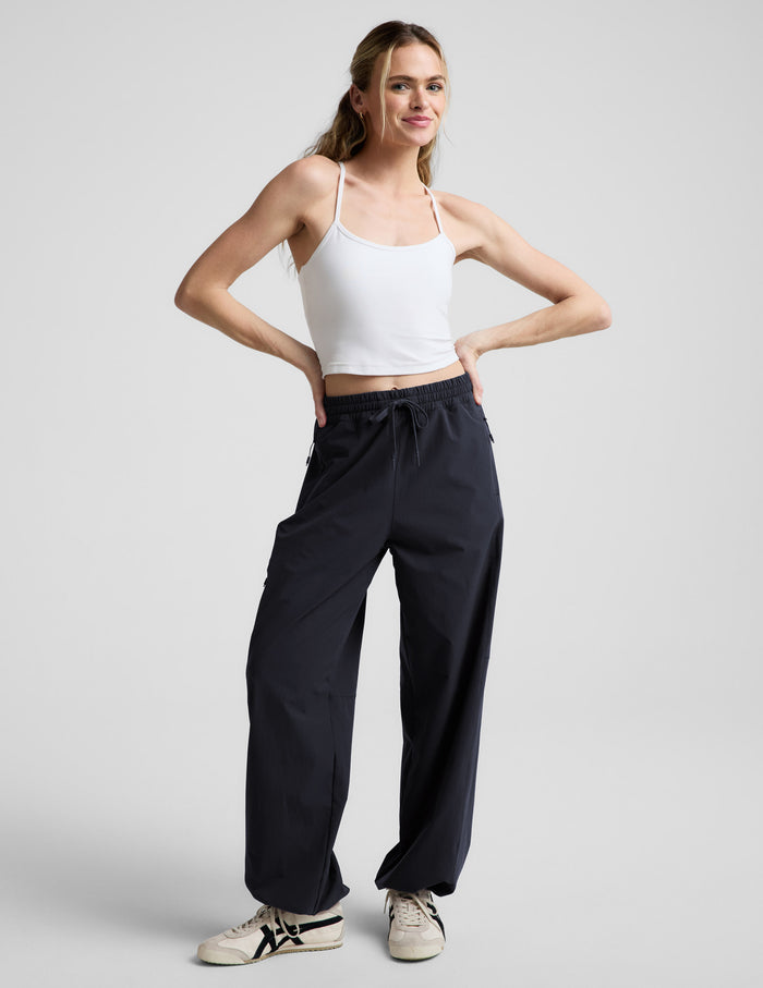 Woman wearing Java Peak Pant™ paired with a white tank top, featuring a drawstring waist and side cargo pockets.