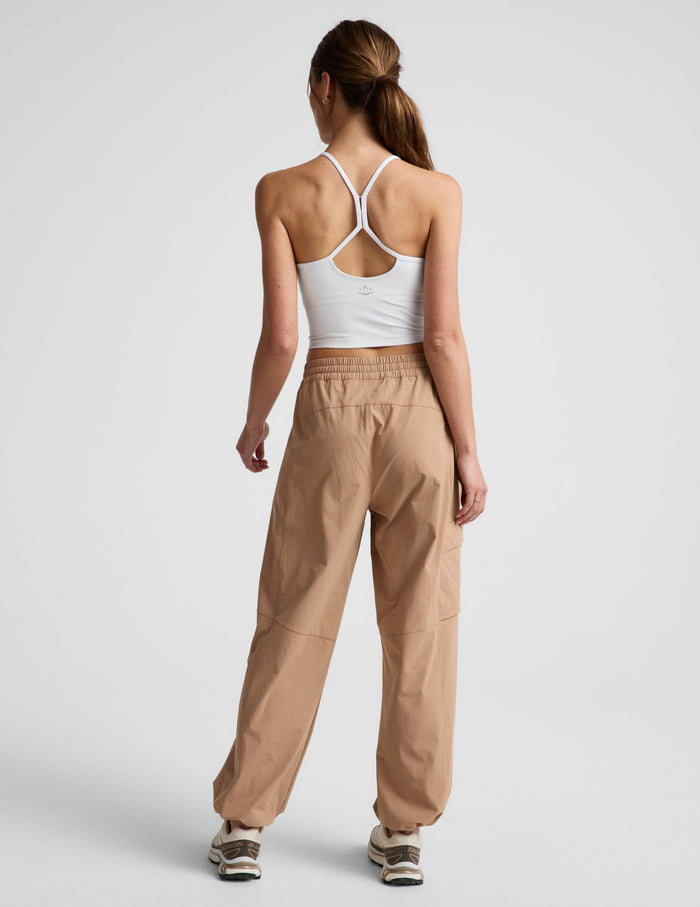 Rear view of woman wearing Java Peak Pant™ paired with a white crop top, featuring a gathered elastic waistband.