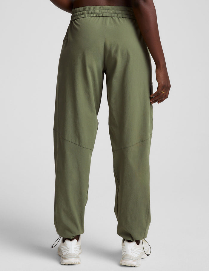Back view of olive Peak Pant with relaxed fit, elastic waistband, and adjustable bungee hems at the ankle.