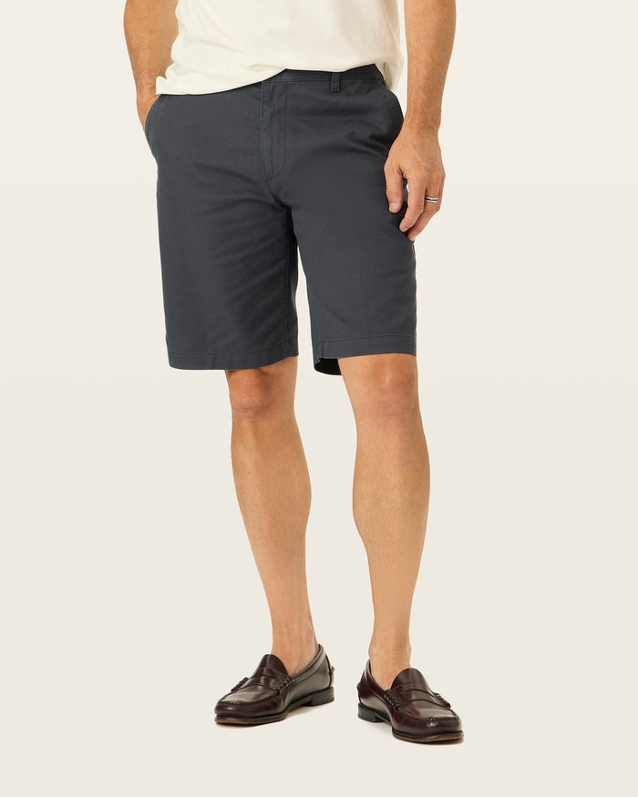 Side view of model wearing Black Perfect 10.5" Shorts.