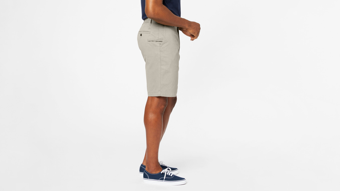 Side view of model wearing Porcelain Khaki Perfect 10.5" Shorts.