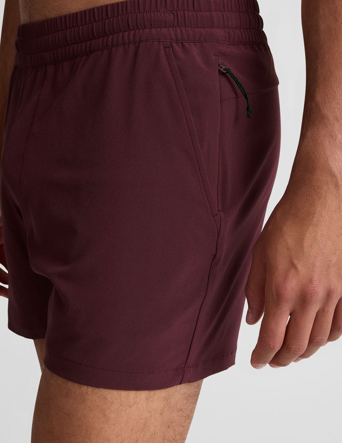Maroon Pivotal 2.0 Men's Short 5" with elastic waistband, side hand pocket, and hidden zipper pull, shown from a side view.