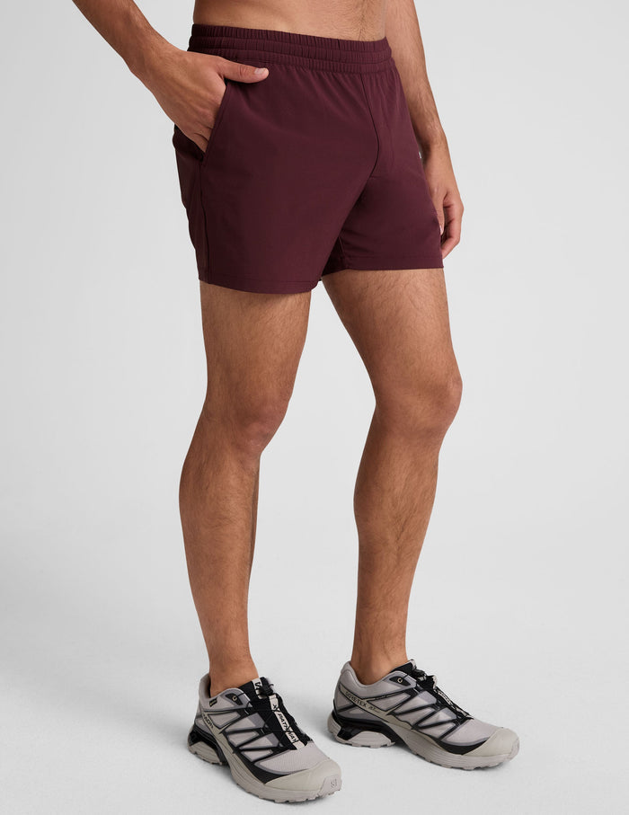 Maroon Pivotal 2.0 Men's Short 5" featuring a gathered elastic waistband and side pockets on a model.