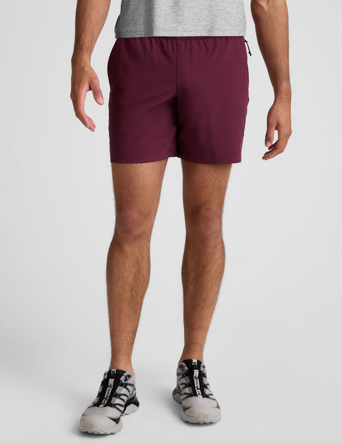 Front view of the maroon Pivotal 2.0 Men's Short 7" on a model, featuring a relaxed fit and gathered elastic waistband.