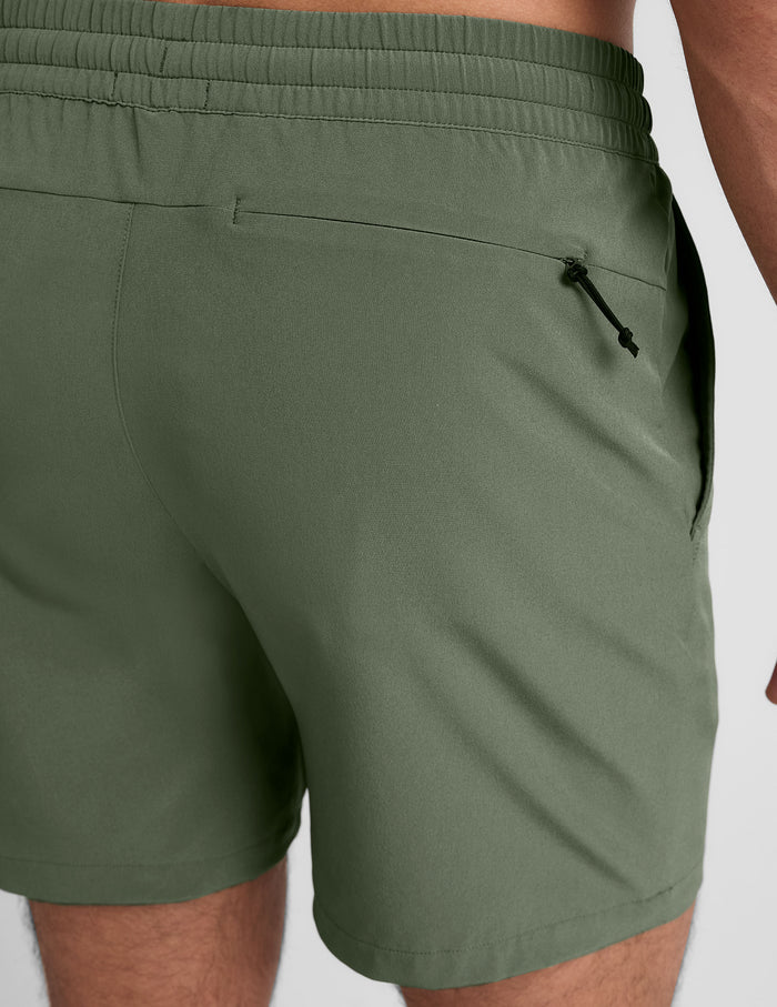 Back view of olive Pivotal 2.0 Men's Short 7" showing the gathered elastic waistband and zippered back pocket.