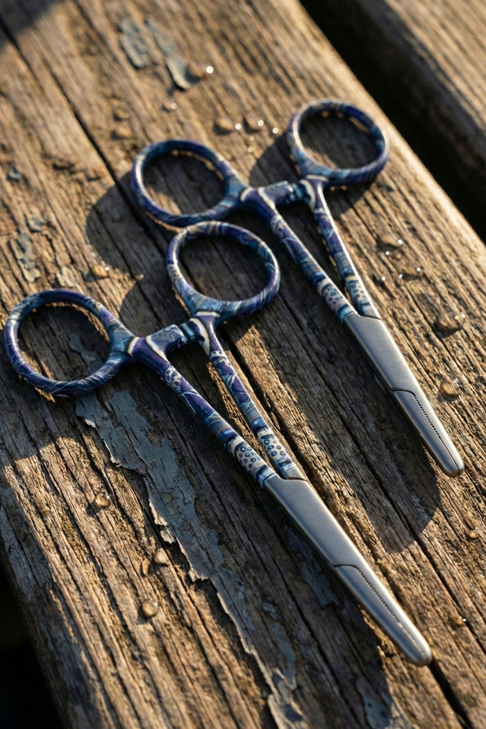 Pair of blue-handled scissors on a wooden surface