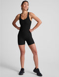 black racerback 5" inseam tank jumpsuit with a front V neckline with overlapping detail.