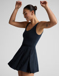 Woman wearing a blue dress against a plain background.