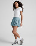 Light blue Score Pleated Skirt, a mini skort with stitched pleats and an A-line fit, worn by a model in a white tee.